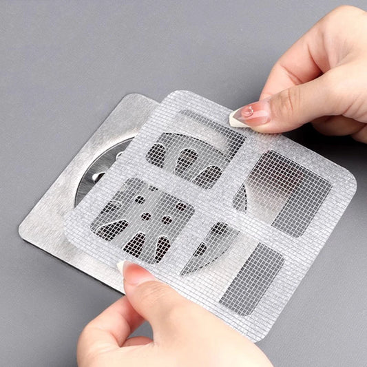 Disposable shower drain hair catcher with a self-adhesive design to prevent clogging and keep drains clean.