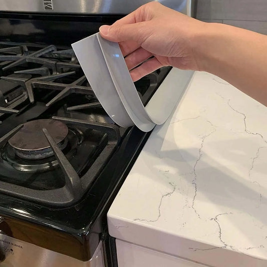 Flexible silicone gap strip for sealing gaps between stoves, countertops, and furniture to prevent spills and debris buildup.